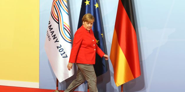 German Chancellor Angela Merkel walks past flags as she arrives before greeting heads of State at the start of the G20 meeting in Hamburg, northern Germany, on July 7.
Leaders of the world's top economies will gather from July 7 to 8, 2017 in Germany for likely the stormiest G20 summit in years, with disagreements ranging from wars to climate change and global trade. / AFP PHOTO / AFP PHOTO AND POOL / LUDOVIC MARIN / SOLELY FOR REUTERS (Photo credit should read LUDOVIC MARIN/AFP/Getty Images)