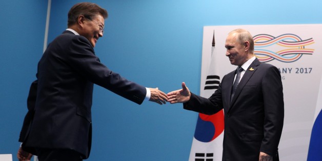 HAMBURG, GERMANY - JULY 7: South Korea's President Moon Jae-in (L) and Russia's President Vladimir Putin (R) shake hands before their bilateral meeting within G20 summit in Hamburg, Germany, on July 7, 2017. Germany is hosting leaders from the worlds 20 largest economies at the Hamburg summit on July 7-8, set to focus on the global economy, trade, climate change, and the fight against international terrorism. (Photo by Stringer/Anadolu Agency/Getty Images)