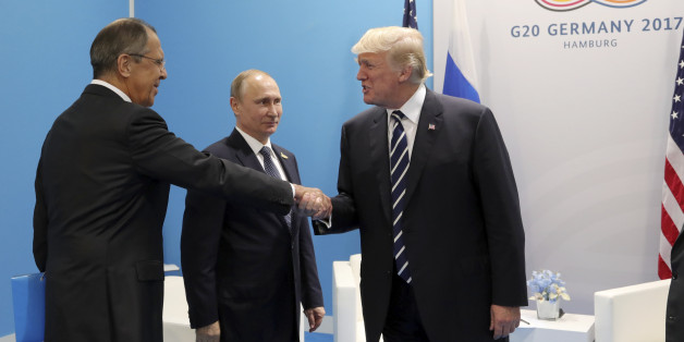 U.S. President Donald Trump (R) shakes hands with Russian Foreign Minister Sergei Lavrov as Russian President Vladimir Putin stands nearby during a meeting on the sidelines of the G20 summit in Hamburg, Germany July 7, 2017 Sputnik/Mikhail Klimentyev/Kremlin via REUTERS ATTENTION EDITORS - THIS IMAGE WAS PROVIDED BY A THIRD PARTY. EDITORIAL USE ONLY.