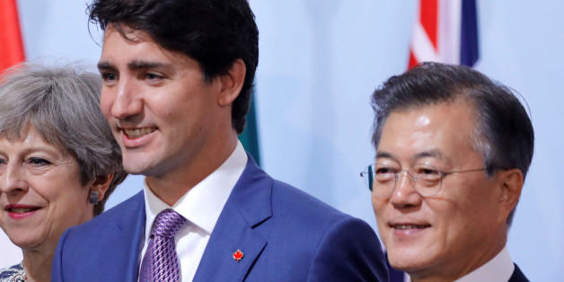 German Chancellor Angela Merkel, Britain's Prime Minister Theresa May, U.S. President Donald Trump, Canadian Prime Minister Justin Trudeau and South Korea's President Moon Jae-in pose for the family photo at the Womenâs Entrepreneurship Finance event during the G20 leaders summit in Hamburg, Germany July 8, 2017. REUTERS/Carlos Barria