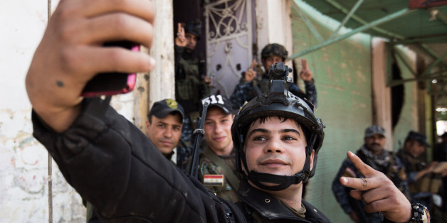 Direct at the frontline, 200 m far from the Al-Nuri-mosque, where Abu Bakr al-Baghdadi calles the so called Caliphate, fighters of the Federal Police are taking a selfie, in Mosul, Iraq, on April 2, 2017. (Photo by Sebastian Backhaus/NurPhoto via Getty Images)
