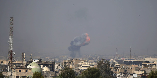 Fire and smoke billow following a reported car bomb explosion as Iraqi forces clash with Islamic State (IS) group fighters in the embattled city of Mosul on April 7, 2017.
The operation by Iraqi forces to retake Mosul has become a slow, grinding battle that has taken a heavy toll on civilians and pushed more than 200,000 to flee. / AFP PHOTO / AHMAD GHARABLI (Photo credit should read AHMAD GHARABLI/AFP/Getty Images)