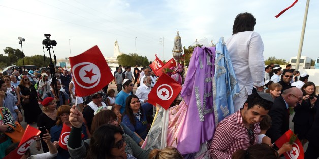 Jewish pilgrims take part in the procession of the 'Menara', a hexagonal pyramid representing prophet Moses' five books, outside the Ghriba synagogue on the Tunisian resort island of Djerba on May 6, 2015, at the start of a two-day annual pilgrimage. The Jewish pilgrimage to Ghriba synagogue is to take place under extra security after the Bardo museum massacre and Israel's warning of terror threats. AFP PHOTO / FETHI BELAID (Photo credit should read FETHI BELAID/AFP/Getty Images)