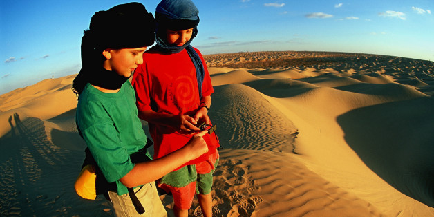 (GERMANY OUT) Tunisia - Boys on a trekking tour navigating in the Grand Erg Oriental. (Photo by Knut Müller/ullstein bild via Getty Images)