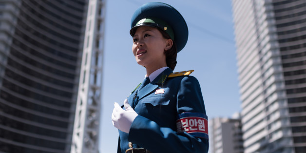 TOPSHOT - In a photo taken on June 5, 2017 a traffic security officer stands on duty at an intersection in Pyongyang.
Officially known as traffic security officers but universally referred to as traffic ladies, they are chosen for their looks in a society that remains traditionalist in many respects. They must leave the role if they marry, and have a finite shelf-life, with compulsory retirement looming at just 26. The 300-odd ladies are unique to Pyongyang, which North Korean authorities are always keen to present in the best possible light despite their nuclear-armed country's impoverished status, and ensure a steady supply of photogenic young women who are the favourite subject of visiting tourists and journalists. / AFP PHOTO / Ed JONES / To go with NKorea-transport-tourism-gender-police, FOCUS by Sebastien Berger (Photo credit should read ED JONES/AFP/Getty Images)