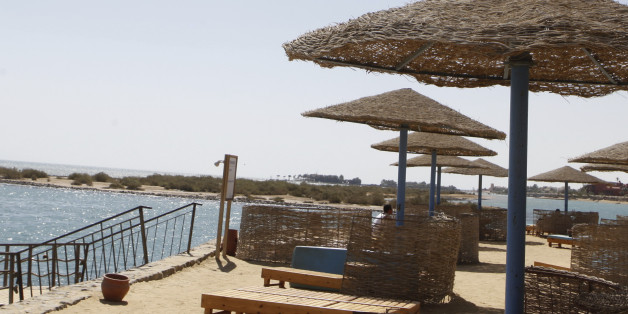 A tourist stands near an empty beach at the coast of the Red Sea of El-Gouna in Hurghada, about 464 km (288 miles) from the capital Cairo, September 11, 2013. According to Egypt's official statistics agency CAPMAS, there was a 25% drop in July 2013 in tourist visits to Egypt due to the country's political crisis. As result, government initiatives have been launched, such as low-priced packages for locals which include air tickets and accommodations in four and five star hotels, to encourage domestic tourism in hopes of increasing hotel occupancy rates, local media said. Picture taken September 11, 2013. REUTERS/Amr Abdallah Dalsh (EGYPT - Tags: POLITICS TRAVEL BUSINESS)