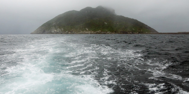 This September 30, 2016 picture shows a view of Okinoshima island, some 60 kilometres from Munakata city, Fukuoka prefecture.The island of Okinoshima and associted sites in the Munakata Region have been inscribed at the 41st session of the UNESCO World Heritage Committee held in Poland on July 9, 2017. / AFP PHOTO / JIJI PRESS / STR / Japan OUT (Photo credit should read STR/AFP/Getty Images)
