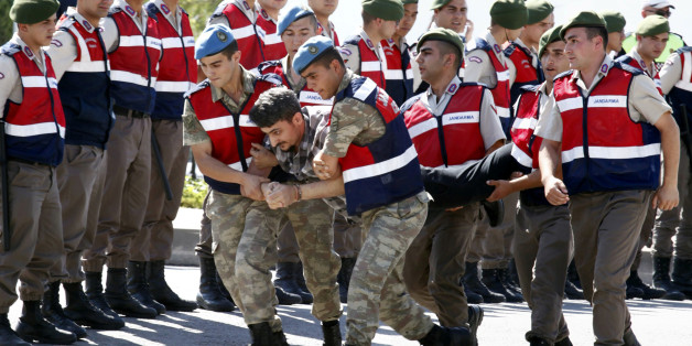 A soldier accused of attempting to assassinate Turkish President Tayyip Erdogan on the night of the failed July 15, 2016 coup is carried by gendarmes to the courthouse in Mugla, Turkey July 14, 2017. REUTERS/Kenan Gurbuz