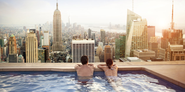 Couple relaxing in swimming pool on hotel rooftop