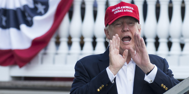 US President Donald Trump yells to well wishers as he arrives at the 72nd US Women's Open Golf Championship at Trump National Golf Course in Bedminster, New Jersey, July 15, 2017. / AFP PHOTO / SAUL LOEB (Photo credit should read SAUL LOEB/AFP/Getty Images)
