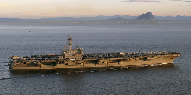 The aircraft carrier USS George H. W. Bush (CVN 77) transits the Strait of Gibraltar into the Mediterranean Sea in this February 27, 2014 picture provided by the U.S. Navy. George H.W. Bush is on a scheduled deployment supporting maritime security operations and theater security cooperation efforts in the U.S. 5th and 6th Fleet areas of responsibility. Picture taken February 27. REUTERS/U.S. Navy/Lt. Juan David Guerra/Handout via Reuters (SPAIN - Tags: MILITARY MARITIME)
ATTENTION EDITORS - THIS IMAGE WAS PROVIDED BY A THIRD PARTY. FOR EDITORIAL USE ONLY. NOT FOR SALE FOR MARKETING OR ADVERTISING CAMPAIGNS. THIS PICTURE IS DISTRIBUTED EXACTLY AS RECEIVED BY REUTERS, AS A SERVICE TO CLIENTS