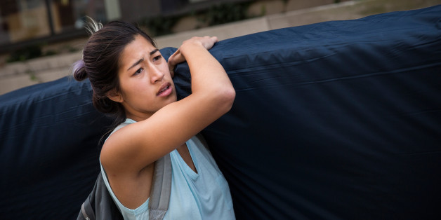NEW YORK, NY - SEPTEMBER 05: Emma Sulkowicz, a senior visual arts student at Columbia University, carries a mattress in protest of the university's lack of action after she reported being raped during her sophomore year on September 5, 2014 in New York City. Sulkowicz has said she is committed to carrying the mattress everywhere she goes until the university expels the rapist or he leaves. The protest is also doubling as her senior thesis project. (Photo by Andrew Burton/Getty Images)