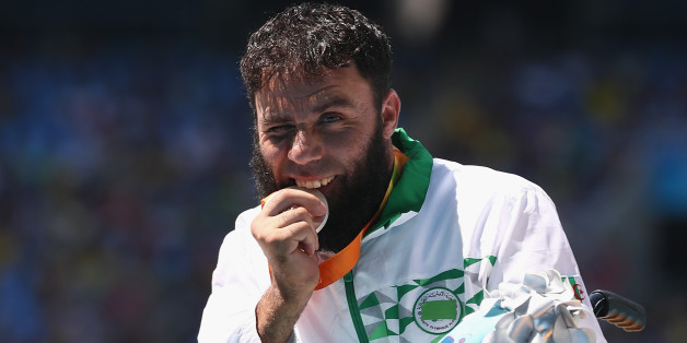 RIO DE JANEIRO, BRAZIL - SEPTEMBER 13: Silver medalist Mohamed Berrahal of Algeria celebrates on the podium at the medal ceremony for the Men's 100m T51 Final during day 6 of the Rio 2016 Paralympic Games at the Olympic Stadium on September 13, 2016 in Rio de Janeiro, Brazil. (Photo by Buda Mendes/Getty Images)