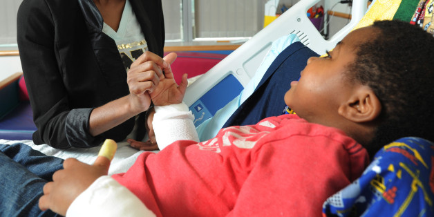 Pattie Ray holds the new right hand of her son, Zion Harvey, 8, in his hospital bed on July 27, 2015, at Children's Hospital of Philadelphia. Zion had a double hand transplant in early July 2015, the first pediatric double hand transplant ever performed. The Baltimore boy lost his hands and feet to a bacterial disease when he was as a two-year-old. (Clem Murray/Philadelphia Inquirer/TNS via Getty Images)