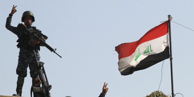 Iraqi federal police members flash the sign for victory as they celebrate in the Old City of Mosul on July 9, 2017 after the government's announcement of the 'liberation' of the embattled city.Iraqi Prime Minister Haider al-Abadi's office said he was in 'liberated' Mosul to congratulate 'the heroic fighters and the Iraqi people on the achievement of the major victory'. / AFP PHOTO / AHMAD AL-RUBAYE (Photo credit should read AHMAD AL-RUBAYE/AFP/Getty Images)