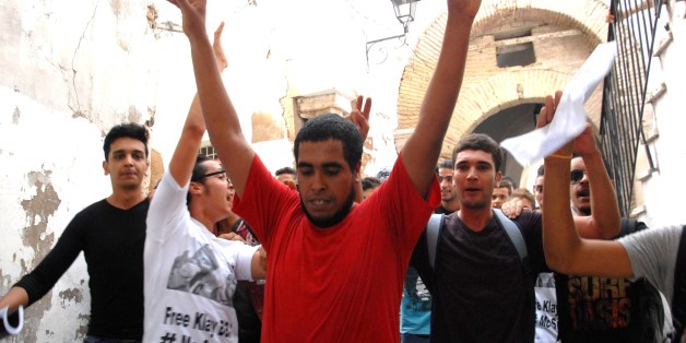 Tunisian rapper Ahmed Ben Ahmed (C), aka Klay BBJ, reacts following his released from custody on October 21, 2015 in Tunis. Klay BBJ was released after being detained over the weekend on suspicion of the 'possession and use' of cannabis, his lawyer said. AFP PHOTO / MOHAMED KHALIL (Photo credit should read MOHAMED KHALIL/AFP/Getty Images)