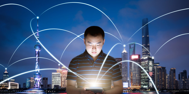 Young man using a digital tablet which is involved in a city network.