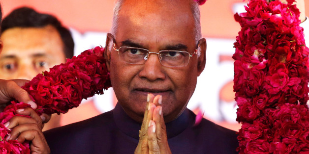 Supporters of Ram Nath Kovind, nominated presidential candidate of Indiaâs ruling Bharatiya Janata Party (BJP), present him with a garland during a welcoming ceremony as part of his nation-wide tour, in Ahmedabad, India, July 15, 2017. REUTERS/Amit Dave
