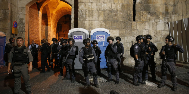 Israeli security forces stand guard outside the Lion's Gate, a main entrance to the Al-Aqsa mosque compound in Jerusalem's Old City, on July 20, 2017, as Palestinians protest against new Israeli security measures implemented at the holy site, which include metal detectors and cameras, following an attack that killed two Israeli policemen the previous week.Israel's army boosted security on July 20 and braced for possible unrest on the eve of the main weekly Muslim prayers after security measures