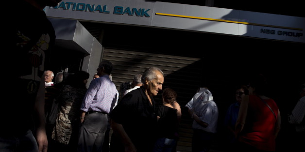 People queue to receive their pensions in front of a National Bank in Athens, Greece, July 2, 2015. Long lines of pensioners jostling to get into a limited number of banks opened specially to pay out retirement benefits have become a powerful symbol of the misery facing Greece and the problems mounting for Prime Minister Alexis Tsipras. REUTERS/Marko Djurica