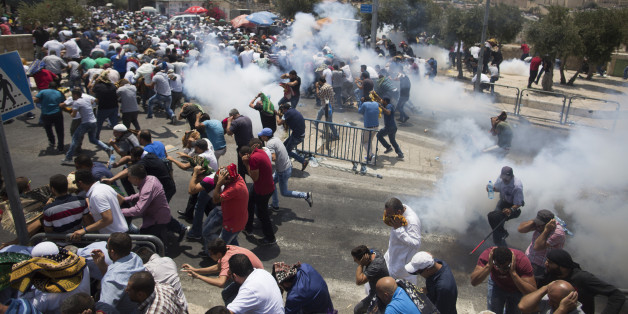 JERUSALEM, ISRAEL - JULY 21: (ISRAEL OUT) Palestinian worshippers run for cover from teargas, fired by Israeli forces, following prayers in Ras el-Amud Area outside the Old City on July 21, 2017 in Jerusalem, Israel. Following last Friday terror attack at the holy site of Al Aqsa mosque Israeli police barred men under 50 from entering the Old City for Friday Muslim prayers as tensions rose and protests erupted over new security measures at the highly sensitive Al-Aqsa mosque compound. (Photo