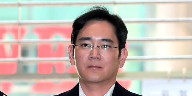 Jay Y. Lee, co-vice chairman of Samsung Electronics Co., center, is escorted by police officers as he arrives at the special prosecutors' office for questioning in Seoul, South Korea, on Saturday, Feb. 25, 2017. Samsung Group's Lee was formally arrested on allegations of bribery, perjury and embezzlement on Feb. 17, an extraordinary step that jeopardizes his ascent to the top role at the world's biggest smartphone maker. Photographer: SeongJoon Cho/Bloomberg via Getty Images