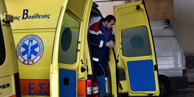TO GO WITH AFP STORY BY SOPHIE MAKRIS A paramedic exits an ambulance outside a hospital on the eastern Greek island of Samos on January 20, 2015. Greece's economic woes mean that paramedics on the picturesque island of Samos are increasingly faced with the terrible dilemma of who to save and who to leave to die. On January 25, Greeks vote in a general election for the second time in three years, with radical leftists Syriza leading the polls with a promise to renegotiate the international bailout that has imposed five years of austerity on the country. AFP PHOTO / ARIS MESSINIS (Photo credit should read ARIS MESSINIS/AFP/Getty Images)