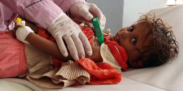 TOPSHOT - A Yemeni child suspected of being infected with cholera is checked by a doctor at a makeshift hospital operated by Doctors Without Borders (MSF) in the northern district of Abs in Yemen's Hajjah province , on July 16, 2017.
The country has also been hit by a cholera outbreak that has killed more than 1,600 people and left some 270,000 infected. / AFP PHOTO / STRINGER (Photo credit should read STRINGER/AFP/Getty Images)
