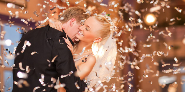 beautiful caucasian couple just married and dancing their first dance