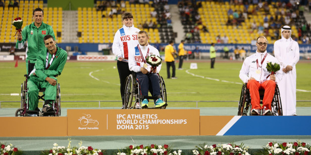 DOHA, QATAR - OCTOBER 26: Vladislav Frolov of Russia poses with his gold medal, Lahouari Bahlaz of ALgeria silver and Maciej Sochal of Poland bronze after the men's club throw F32 final during the Evening Session on Day Five of the IPC Athletics World Championships at Suhaim Bin Hamad Stadium on October 26, 2015 in Doha, Qatar. (Photo by Warren Little/Getty Images)