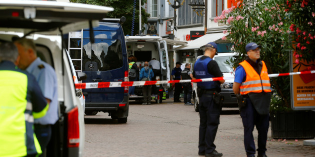 Swiss police officers stand at a crime scene in Schaffhausen, Switzerland July 24, 2017. REUTERS/Arnd Wiegmann