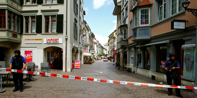 Swiss police officers stand at a crime scene in Schaffhausen, Switzerland July 24, 2017. REUTERS/Arnd Wiegmann