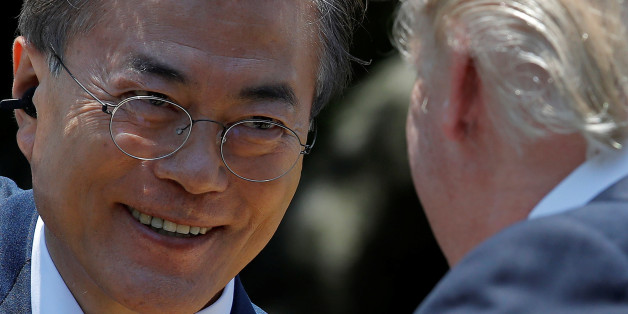 South Korean President Moon Jae-in looks at U.S. President Donald Trump after delivering a joint statement from the Rose Garden of the White House in Washington, U.S., June 30, 2017. REUTERS/Carlos Barria
