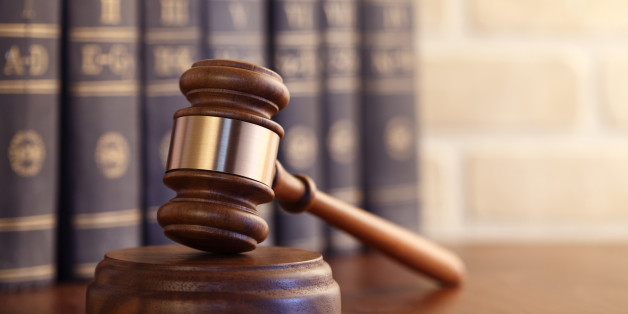 Gavel leaning against a row of law books