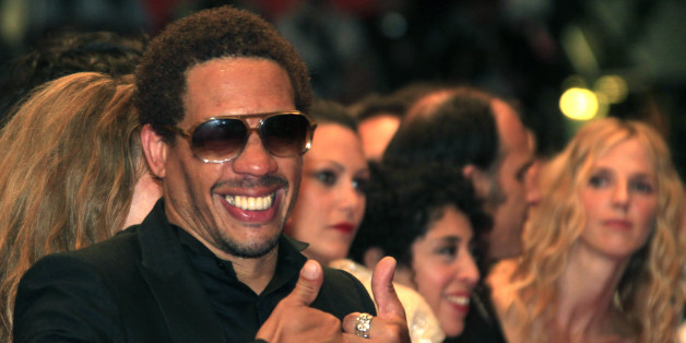Actor Joey Starr gestures as he arrives on the red carpet for the screening of the film "Polisse", by director Maiwenn, in competition at the 64th Cannes Film Festival, May 13, 2011. REUTERS/Jean-Paul Pelissier (FRANCE - Tags: ENTERTAINMENT)