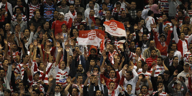 Fans of Tunisia's Club Africain celebrate their team's goal against Morocco's MAS during the first leg soccer match of their Confederation Cup final at Rades Olympic stadium in Tunis November 19, 2011. REUTERS/Zoubeir Souissi (TUNISIA - Tags: SPORT SOCCER)
