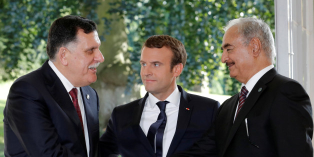French President Emmanuel Macron stands between Libyan Prime Minister Fayez al-Sarraj (L), and General Khalifa Haftar (R), commander in the Libyan National Army (LNA), who shake hands after talks over a political deal to help end Libyaâs crisis in La Celle-Saint-Cloud near Paris, France, July 25, 2017. REUTERS/Philippe Wojazer TPX IMAGES OF THE DAY