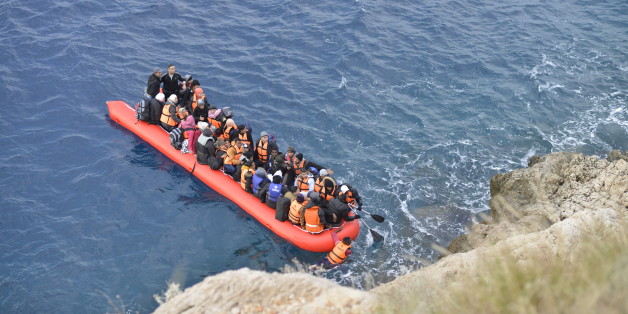 Kas,Turkey - January 16, 2016, Coast line between Kalkan Kas at 09:45. An inflatable boat filled with refugees and other migrants approaches the south coast of the Turkey. Picture captured from Kalkan Kas Road D400.