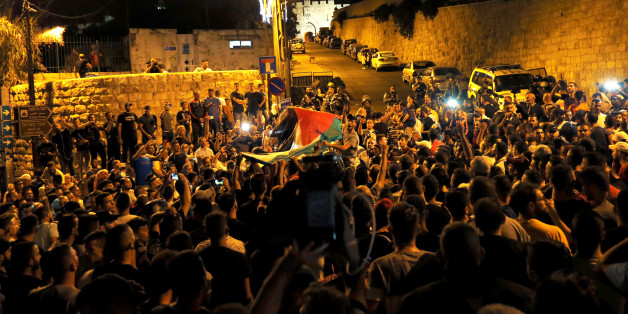 Palestinians celebrate outside Lion's gate at the entrance to Jerusalem's Old City following Israel's removal of security measures July 27, 2017. REUTERS/Muammar Awad
