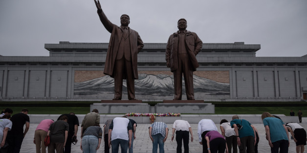 A group of tourists bow before statues of late North Korean leaders Kim Il-Sung (L) and Kim Jong-Il (R), on Mansu hill in Pyongyang on July 23, 2017.
The Westerners lined up before giant statues of North Koreas founder Kim Il-Sung and his son and successor Kim Jong-Il on Sunday and, on command from their guide, bowed deeply - a ritual that the Trump administration intends to stop US tourists performing, with Washington due to impose a ban on its citizens holidaying in the Democratic People's Republic of Korea (DPRK), as the North is officially known. / AFP PHOTO / Ed JONES / TO GO WITH AFP STORY NKOREA-US-TOURISM-DIPLOMACY,FOCUS BY SEBASTIEN BERGER (Photo credit should read ED JONES/AFP/Getty Images)