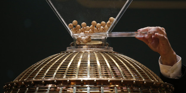A man puts the balls into the lottery drum before the draw for Spain's Christmas Lottery "El Gordo" in Madrid December 22, 2014. The total prize money of 2.4 billion euros is split into thousands of cash prizes amongst hundreds of winning numbers. REUTERS/Juan Medina (SPAIN - Tags: SOCIETY)