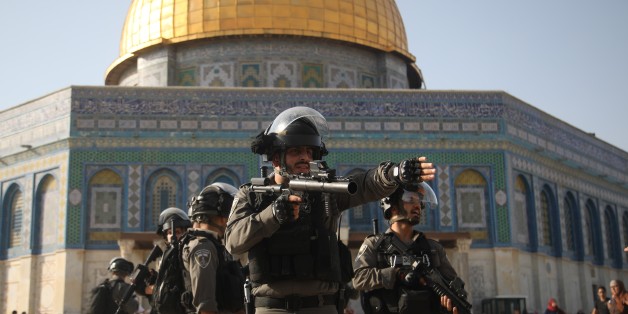 JERUSALEM - JULY 27 : Israeli forces intervene to Palestinians with tear gas bomb as they gather to enter the Al Aqsa Mosque following the removal of Israeli security measures near the entrances to Al Aqsa Mosque Compund in Jerusalem, on July 27, 2017. Palestinian Muslims have been praying in the streets outside the mosque complexs ancient walls since July 14 in protest at Israeli security measures and restrictions. Muslims will return to Al-Aqsa Mosque to pray for the first time in nearly two w