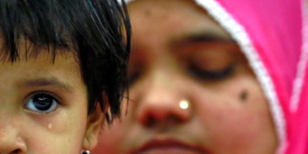 Aksha Yakub Rasool, 2, sits on her mother Bilkis Bano's (R) knee during a press conference in New Delhi, India May 8, 2017. Bilkis was gang raped and fourteen of her relatives, including her three-year-old daughter, were killed during religious riots that broke out in Gujarat in 2002. Last week a court in Mumbai upheld the conviction of 11 men to life in prison for the rape and murder. REUTERS/Cathal McNaughton TPX IMAGES OF THE DAY
