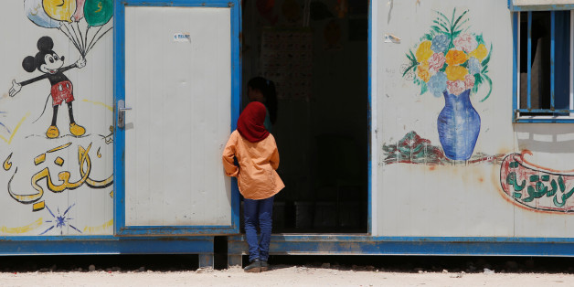 A Syrian girl looks into a room at a school run by Relief International in Al Zaatari refugee camp outside the city of Mafraq in Jordan, near the border with Syria, July 17, 2017. Picture taken July 17, 2017. REUTERS/Darrin Zammit Lupi