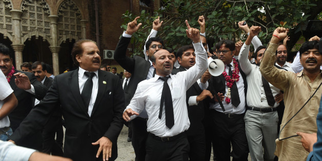Pakistani lawyers celebrate the Supreme Court (SC) against Prime Minister Nawaz Sharif, in Lahore on July 28, 2017. Pakistan's Supreme Court on July 28 disqualified Prime Minister Nawaz Sharif from public office over long-running corruption allegations, a decision that ousts him from the premiership for the third time in a chequered political career. / AFP PHOTO / ARIF ALI (Photo credit should read ARIF ALI/AFP/Getty Images)