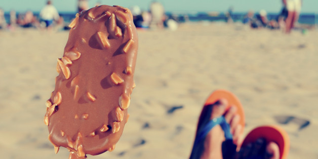 young man having an appetizing ice cream on the beach