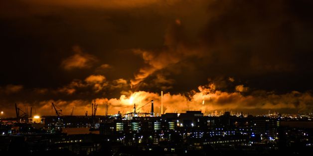 A photo taken at night on July 29, 2017 shows flames and smoke rising above the Shell refinery in Rotterdam.A fire broke out on the night of July 29 at the Shell refinery in Rotterdam, the largest in Europe, causing part of the site to be shut down. / AFP PHOTO / ANP / Björn Remmerswaal / Netherlands OUT (Photo credit should read BJORN REMMERSWAAL/AFP/Getty Images)