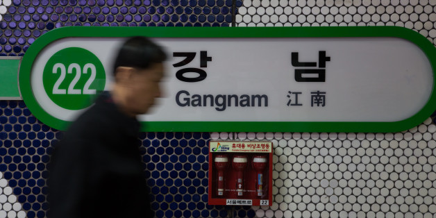 A man walks past signage for Gangnam subway station in Seoul, South Korea, on Thursday, Dec. 13, 2012. South Koreans vote on Dec. 19 to replace President Lee Myung Bak, whose five-year term ends in February. Photographer: SeongJoon Cho/Bloomberg via Getty Images