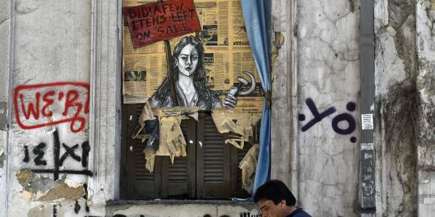 TOPSHOT - A man walks past a political graffiti in central Athens by artist Bleeps reading' Bid! a few items left on sale' on May 4, 2017 one day after Greece and its creditors closed a troubled chapter on fiscal reforms with a preliminary deal on pension and tax cuts, offering hope for a debt relief agreement later this month
Greece and its creditors on May 3rd closed a troubled chapter on fiscal reforms with a preliminary deal on pension and tax cuts, offering hope for a debt relief agreement later this month. The nation's debt in 2016 stood at nearly 315 billion euros or 179 percent of annual economic output, up from 177.4 percent in 2015. / AFP PHOTO / LOUISA GOULIAMAKI (Photo credit should read LOUISA GOULIAMAKI/AFP/Getty Images)
