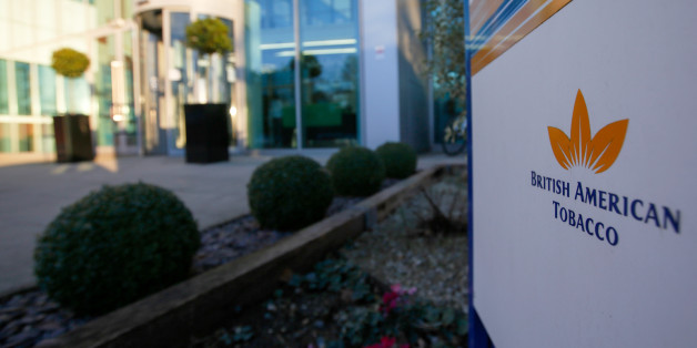 The British American Tobacco Plc logo sits on a sign standing outside their research and development laboratories in Southampton, U.K., on Wednesday, Jan. 18, 2017. BAT, the maker of Lucky Strike and Pall Mall cigarettes, forecast earnings growth this year as it completes its purchase of Reynolds American Inc. and expands sales of a smoking alternative product across Japan to catch up with Philip Morris International Inc. Photographer: Luke MacGregor/Bloomberg via Getty Images